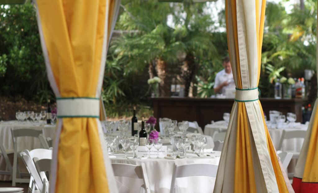 Curtains, dining tables, and bar at the Lobero Courtyard