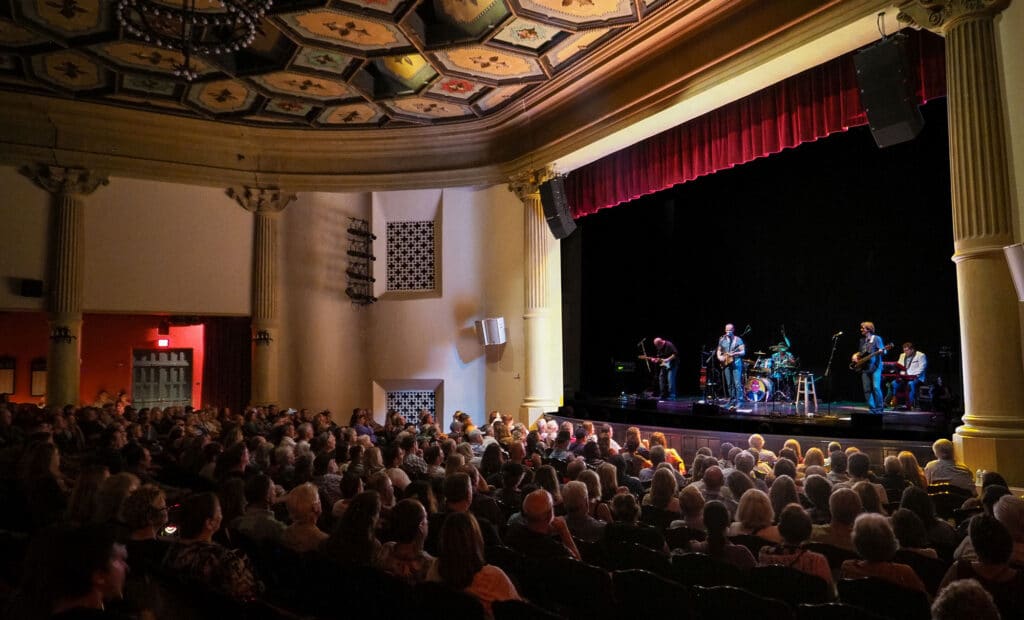 View of a band on stage with the audience watching