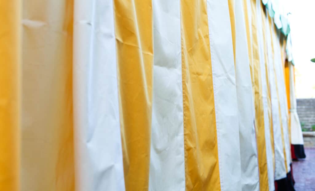 Yellow and white striped tent over the Lobero Theatre Courtyard