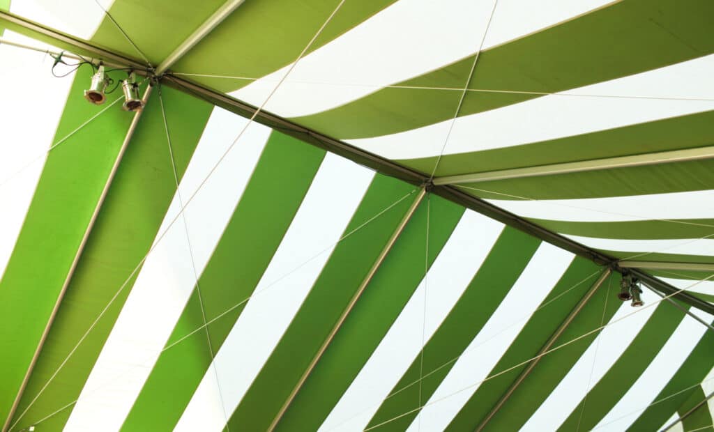 Green and white striped tent over the Lobero Theatre Courtyard