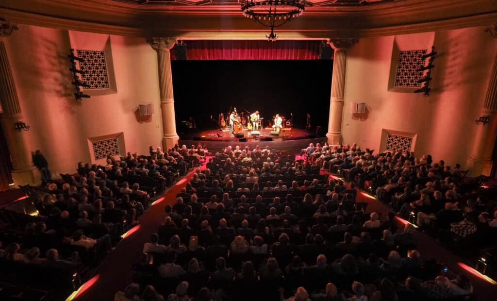 View of a band playing on stage from the sound booth at the Lobero Theatre