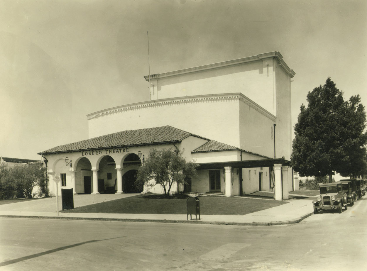 Black and white photo of Lobero Theatre with old cars